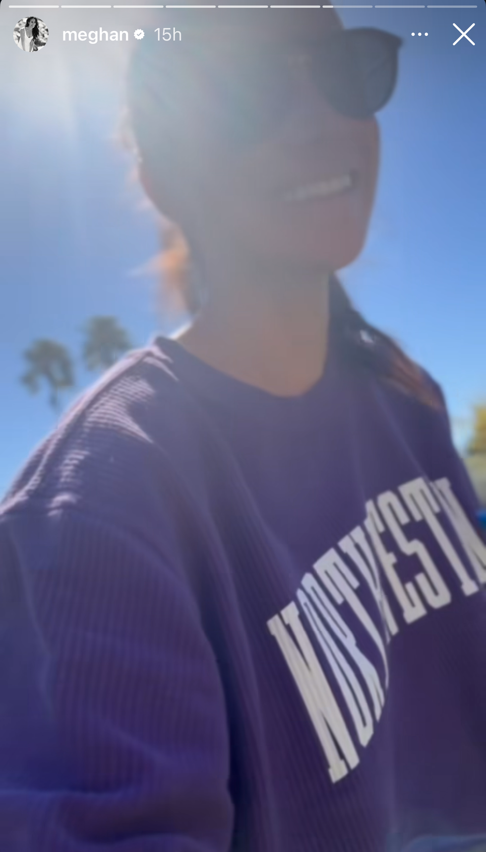 A smiling woman wearing sunglasses and a Northwestern University sweatshirt.