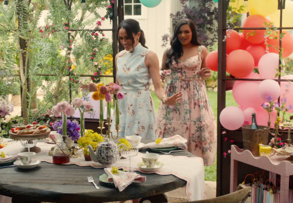 outdoor gathering with a decorated table and floral arrangements